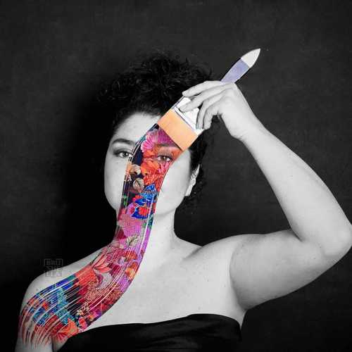 Gabriela painting on a large canvas in her art studio